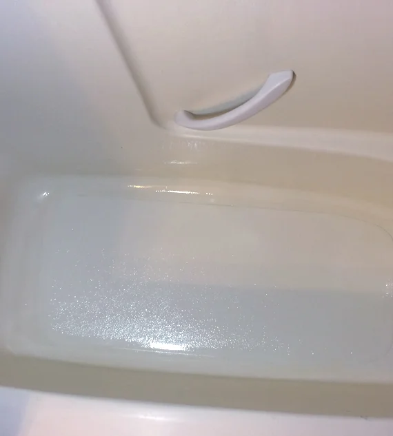 Tub inlay installed in a one piece tub and shower unit