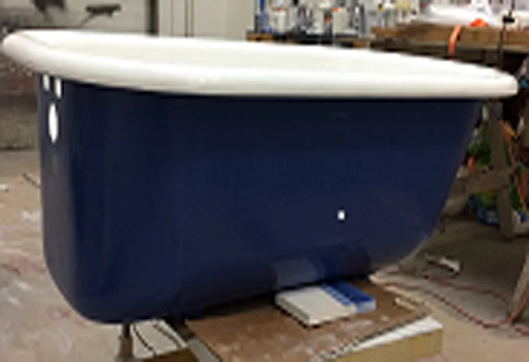 Picture of a clawfoot tub that has a white interior and a blue exterior